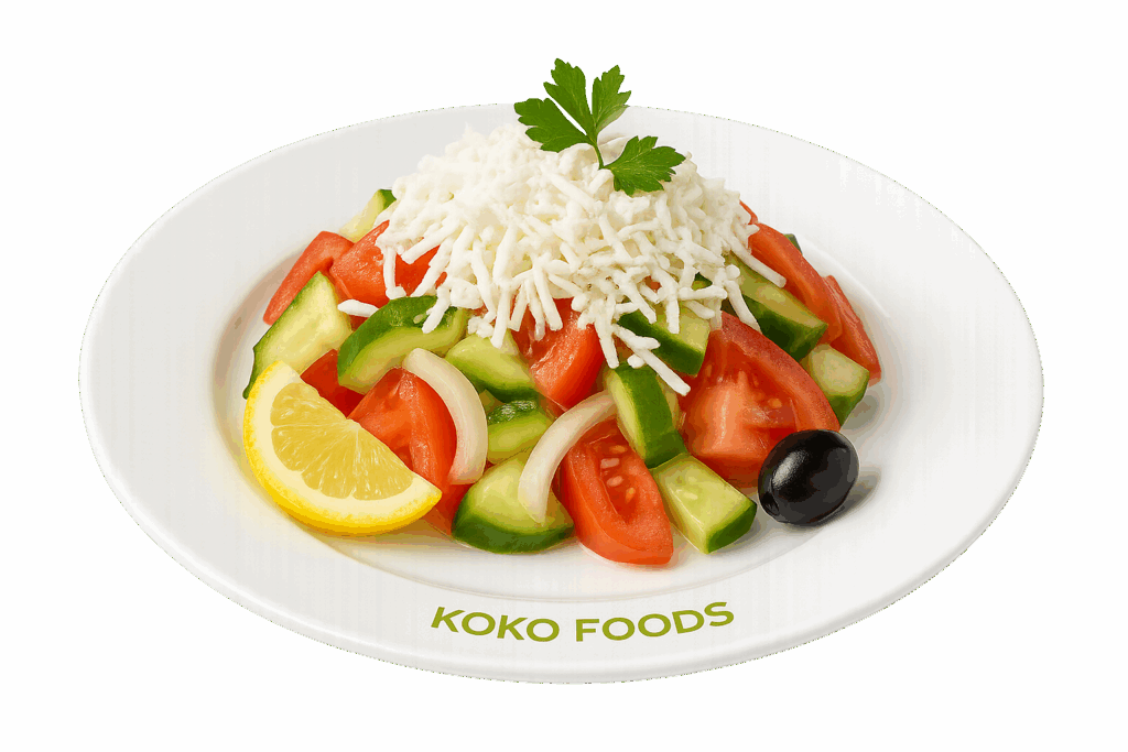 Шопска салата с домати, краставици, сирене и чушки – сервирана в чиния от Koko Foods Казанлък